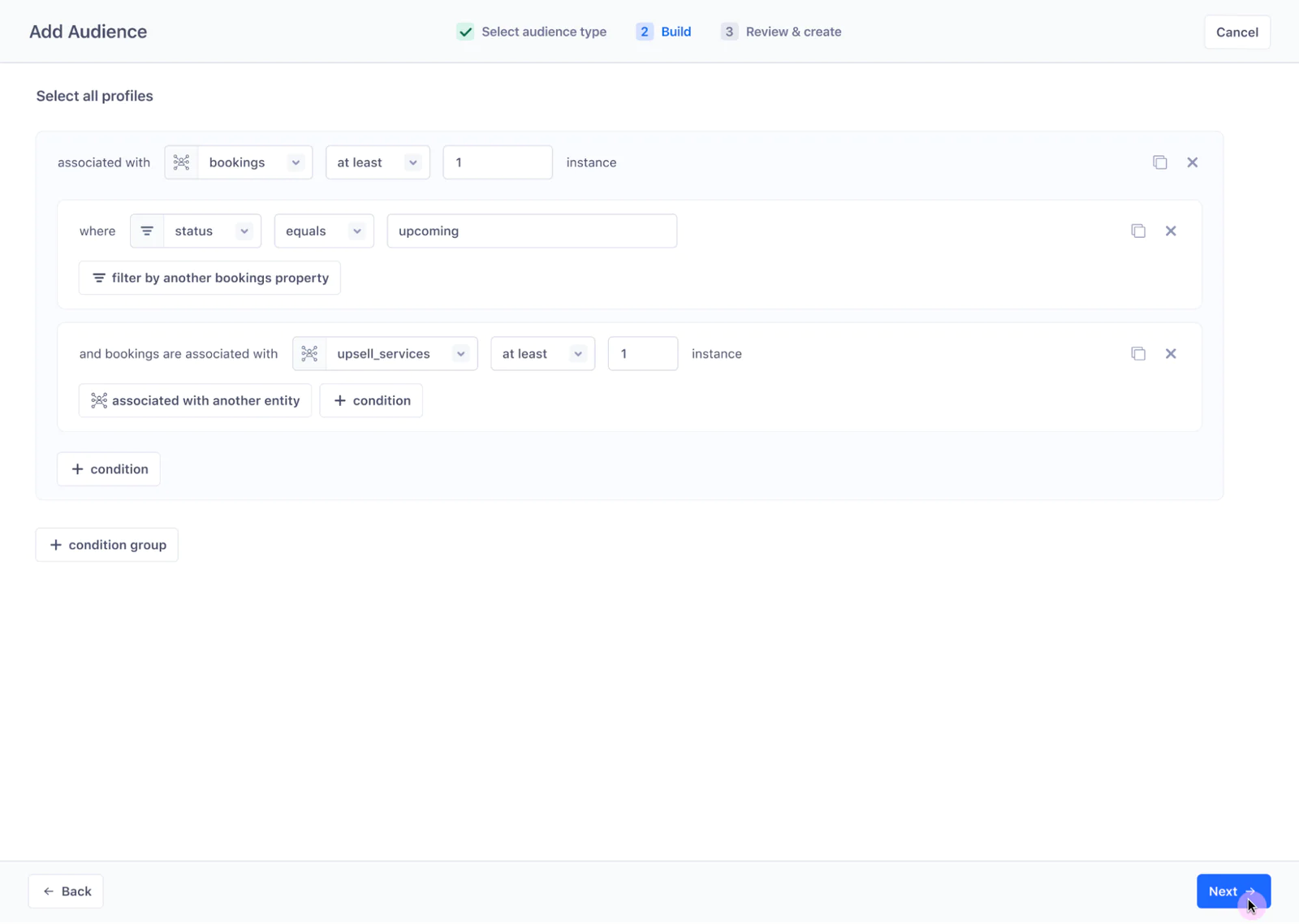 Audience builder interface with multiple conditions set for selecting user profiles based on bookings and associated upsell services, with a "Next" button highlighted.
