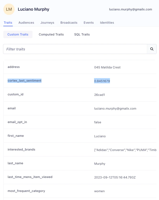 User profile page displaying traits such as cortex_last_sentiment, address, email, opt-in status, interested brands, and last viewed time.