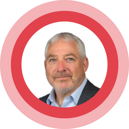 Portrait of a white-haired man with a beard in a red circular frame.