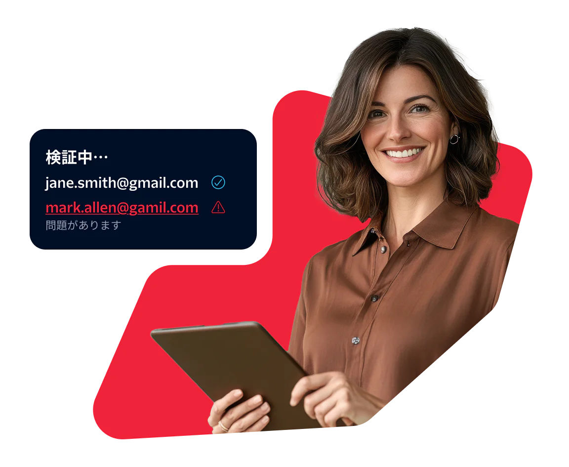 Woman using a tablet while validating email addresses Woman holding a tablet with a screen showing email validation results