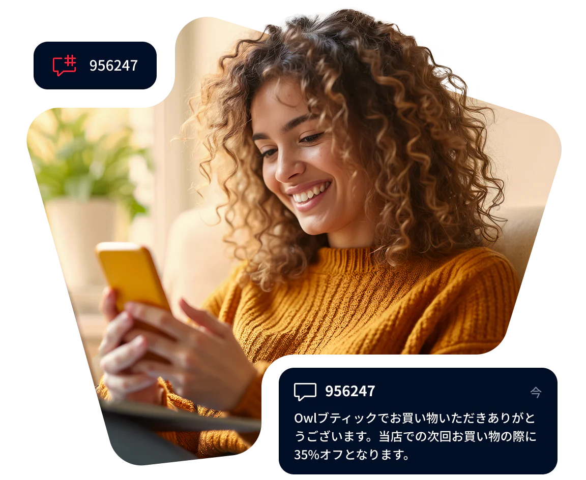Smiling woman looking at smartphone with discount notification popup on screen.