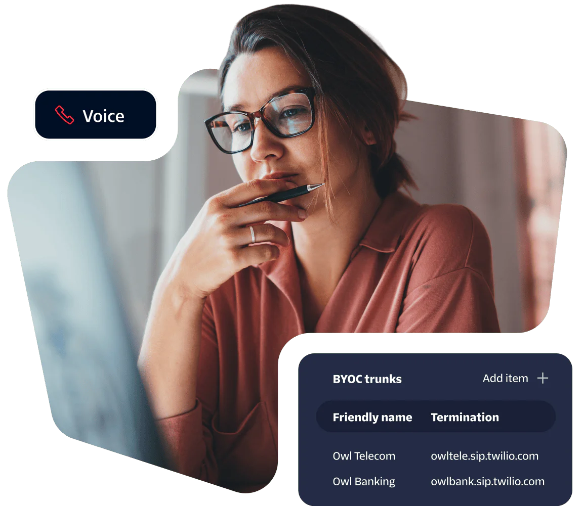 Woman in glasses looks intently at monitor, viewing telecommunications trunk terminations on screen.