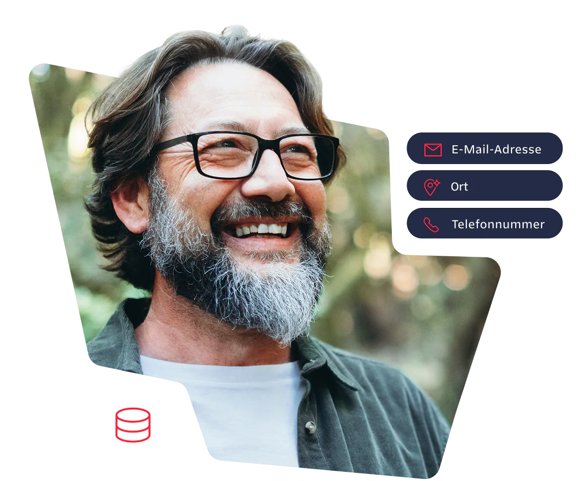 Happy man with glasses and beard in a forest setting Smiling man with glasses and beard standing outdoors in a forest background.