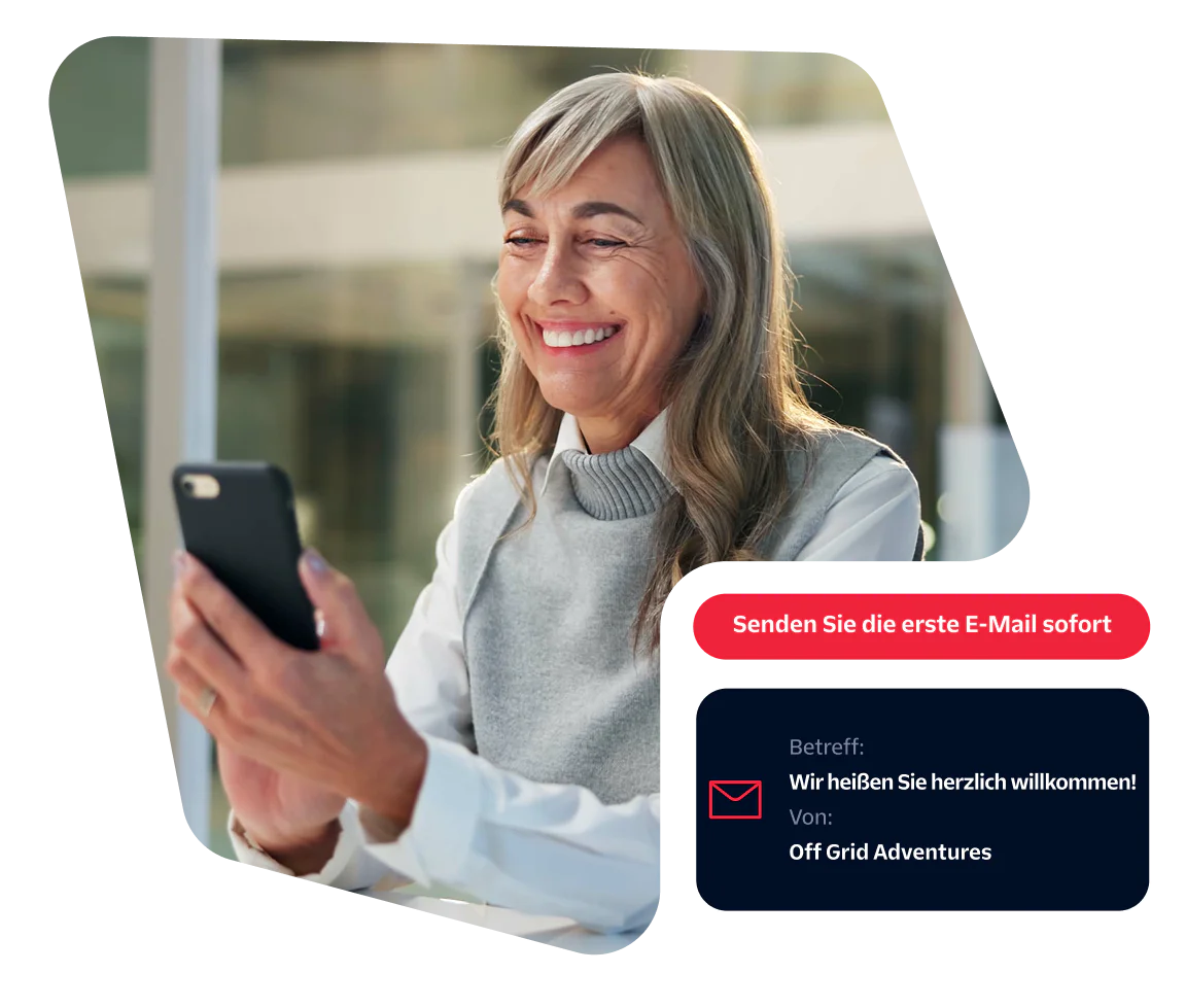 Smiling older woman using a smartphone with a pop-up message prompt to send the first email instantly.