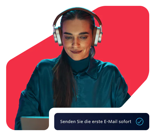 Woman wearing headphones working on her laptop Woman in headphones using a laptop with a prompt to send the first email instantly