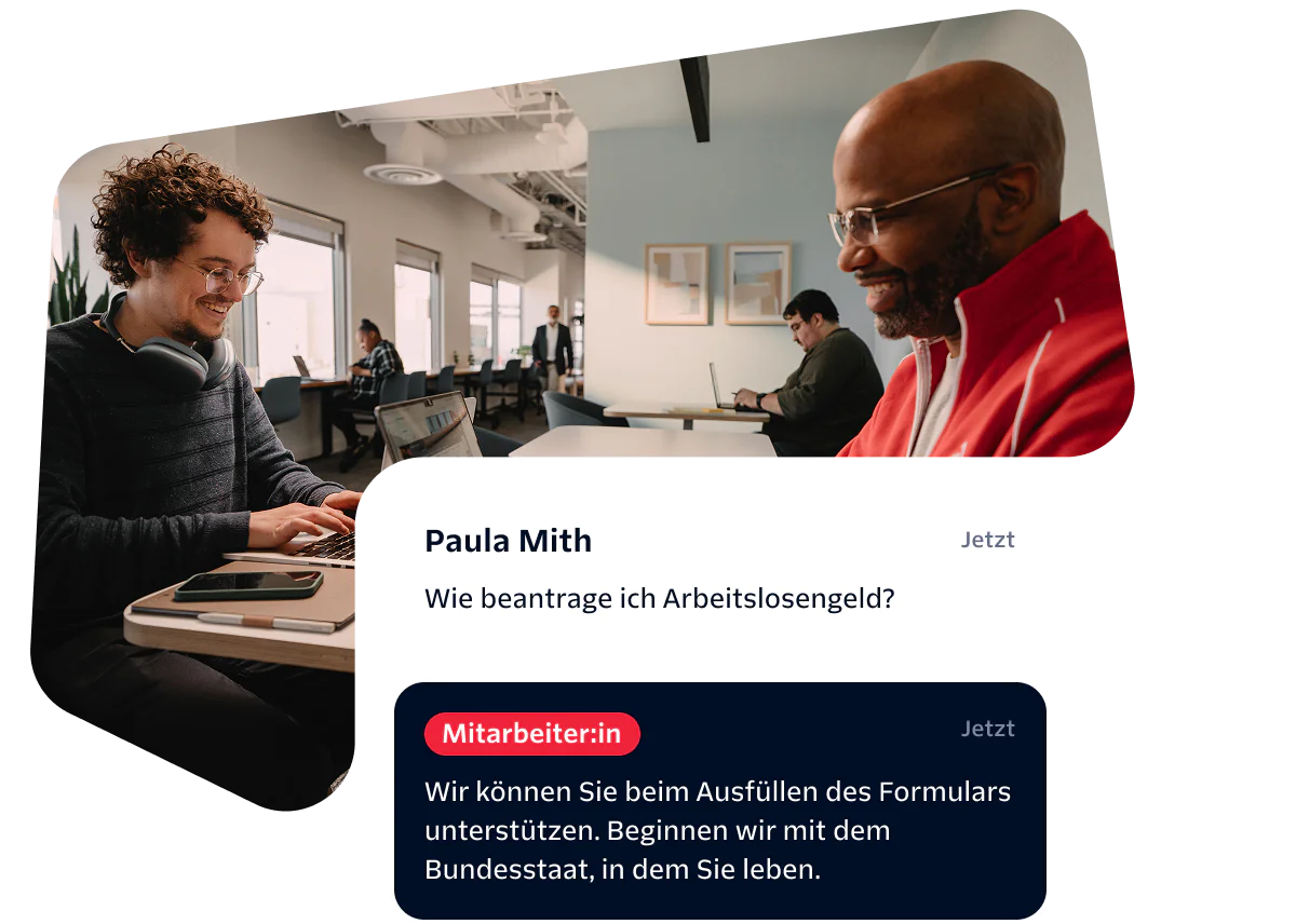 Two people working in an office, with a conversation about unemployment benefits on the screen.