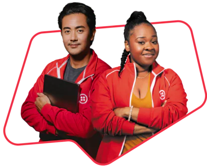 Two people in red jackets smiling and crossing their arms