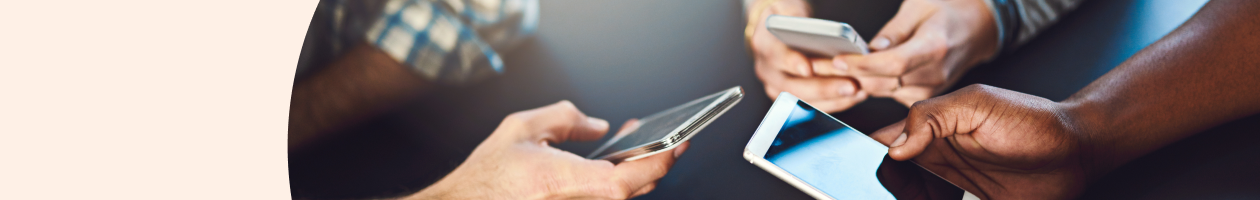 Three people holding and using smartphones together