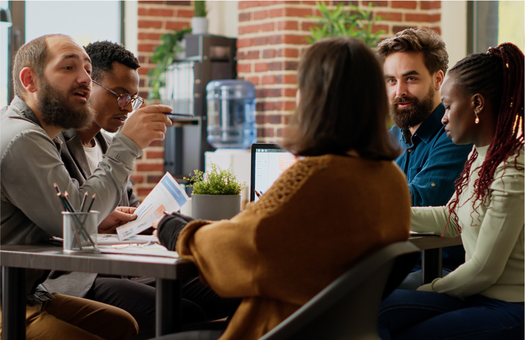 Managers at a table discussing permissions for viewing agent conversations