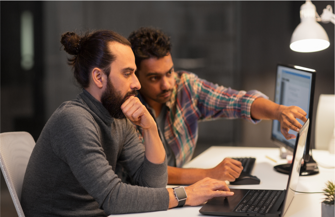 Coworkers building a messaging API PoC on a laptop