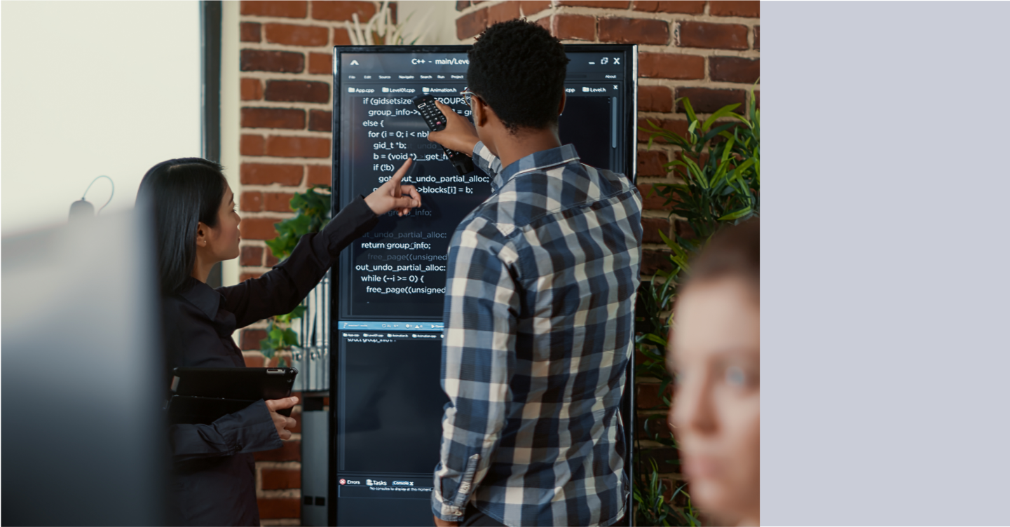 Colleagues reviewing Voice SDK on large screen