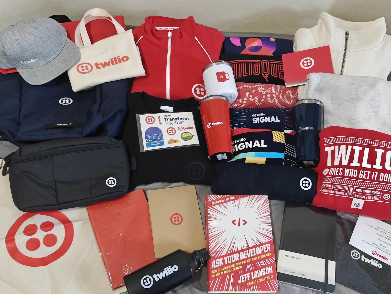 Various Twilio-branded merchandise items including clothing, bags, and accessories displayed.