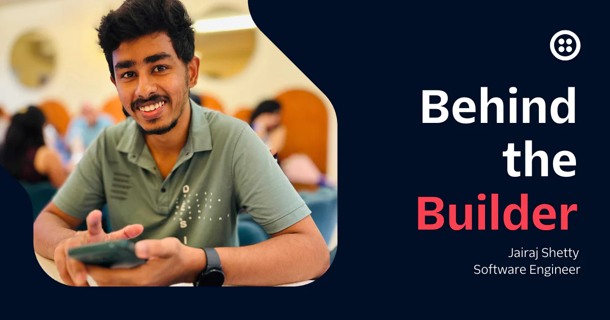 Smiling man holding a phone with Behind the Builder text next to him.