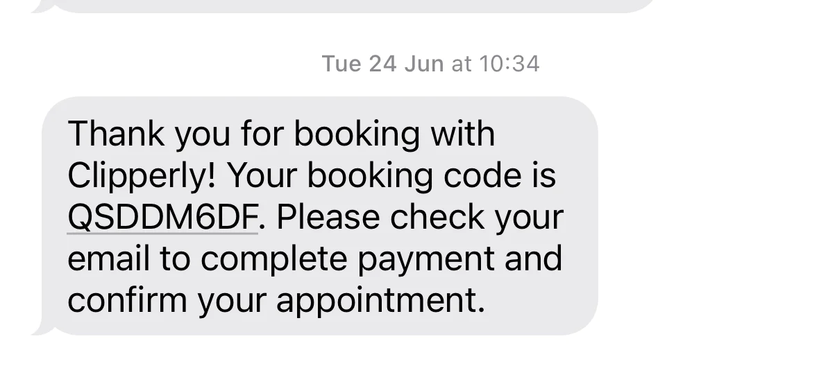A text message confirming a booking and providing a code.