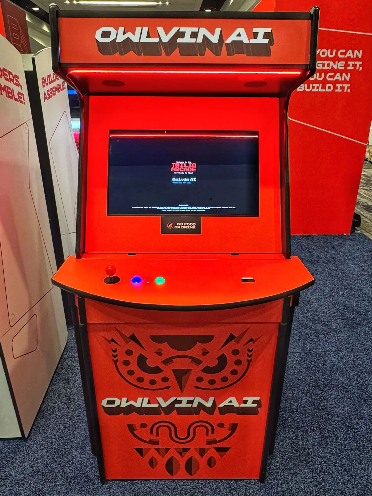 Bright red arcade machine with Owlvin AI text and graphics. Bright red arcade machine with Owlvin AI text and graphics.