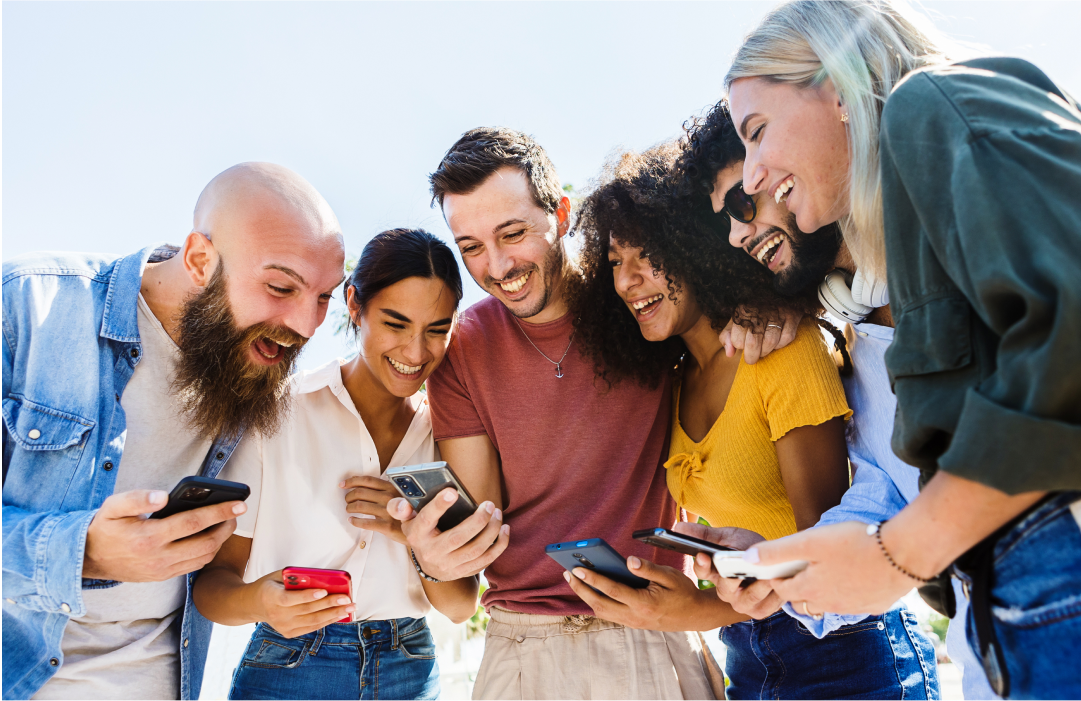 Group of friends gathered around a mobile device