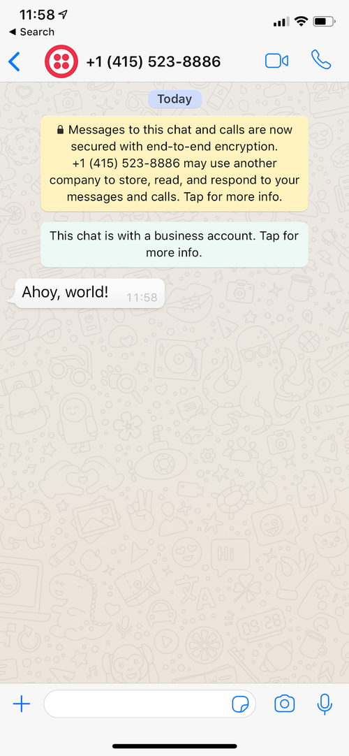 Message WhatsApp sur écran de téléphone portable