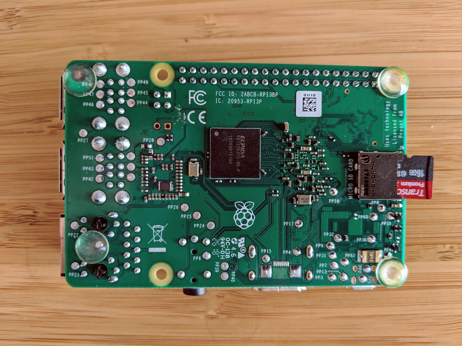 The bottom of a Raspberry Pi. A SD card is sticking out of it.