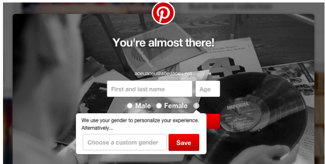 A screenshot of Pinterest's expanded gender options on signup. There are input boxes for "First and last name" and "age." There are radio buttons for "male" and "female" along with an info icon. There's a tooltip on the info icon that says "We use your gender to personalize your experience" with a textbox that says "Choose a custom gender" that can be any text value.