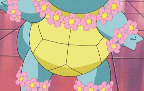 Gif of a Squirtle pokemon wearing flowers on its head, neck, and wrist winking at you with its wrist behind its head.