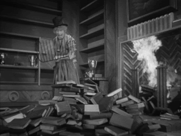 Black and white animated gif of a person in a top hat shoveling books into a fireplace.