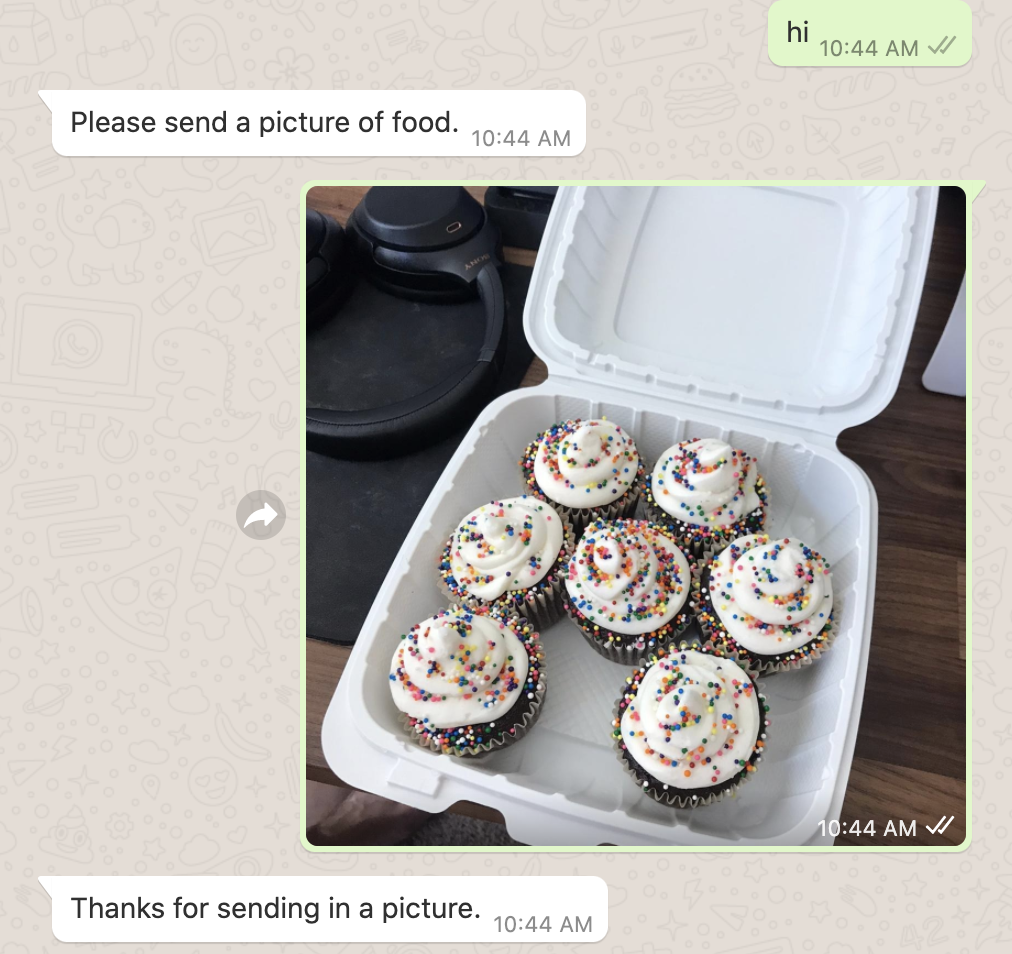 screenshot of user sending in a picture of cupcakes to the WhatsApp program. WhatsApp responds with "thanks for sending in a picture"