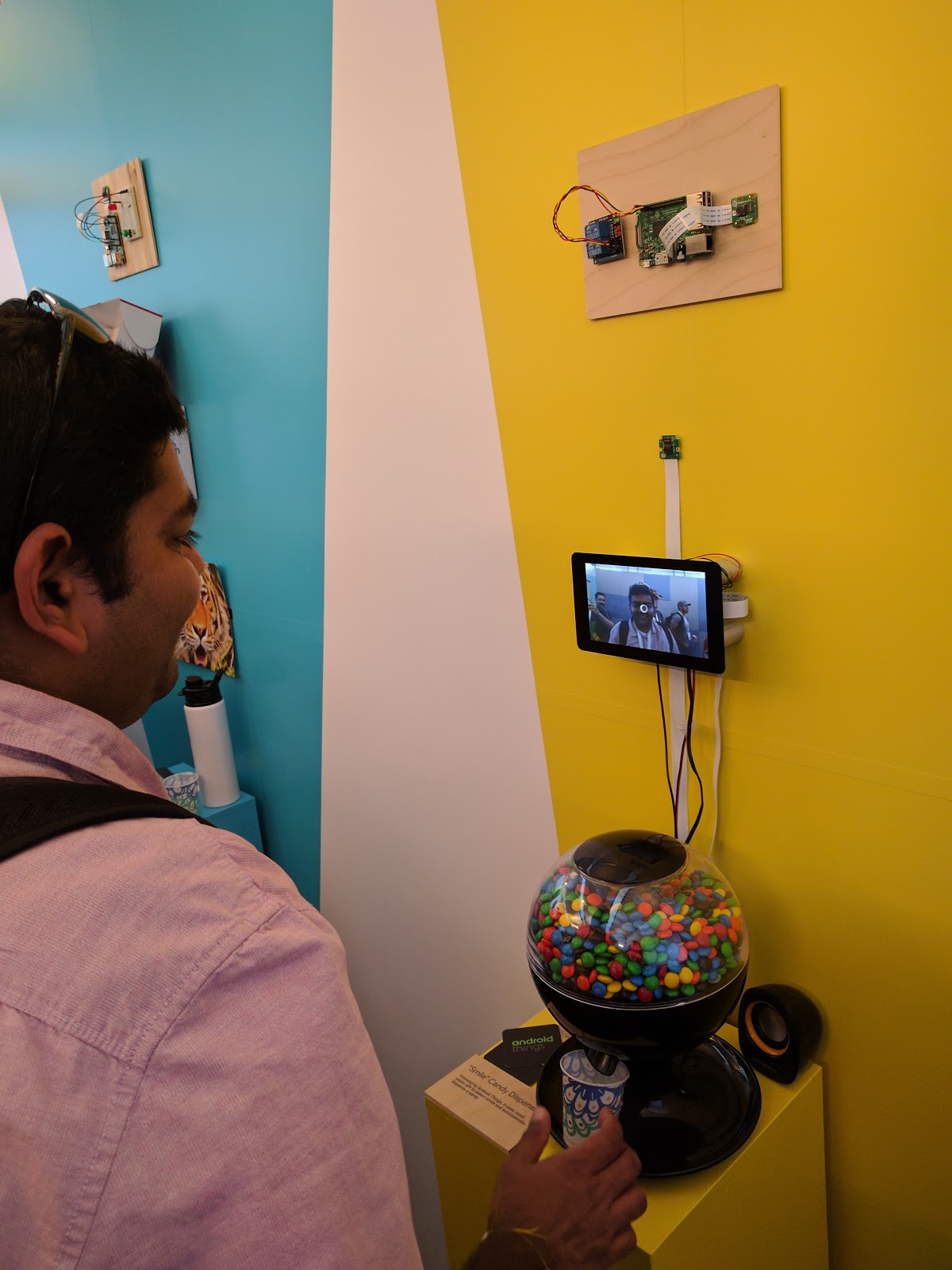 Attendant experimenting the "Smile dispenser" demo at Google I/O 2017