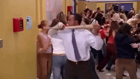 man angrily smashes the fire alarm at school