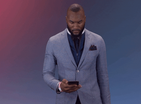 Animgif of a person being surprised to get a message on their phone.