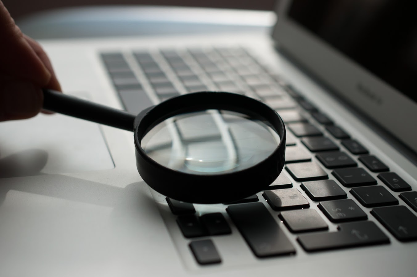 Picture of a magnifying glass over a keyboard