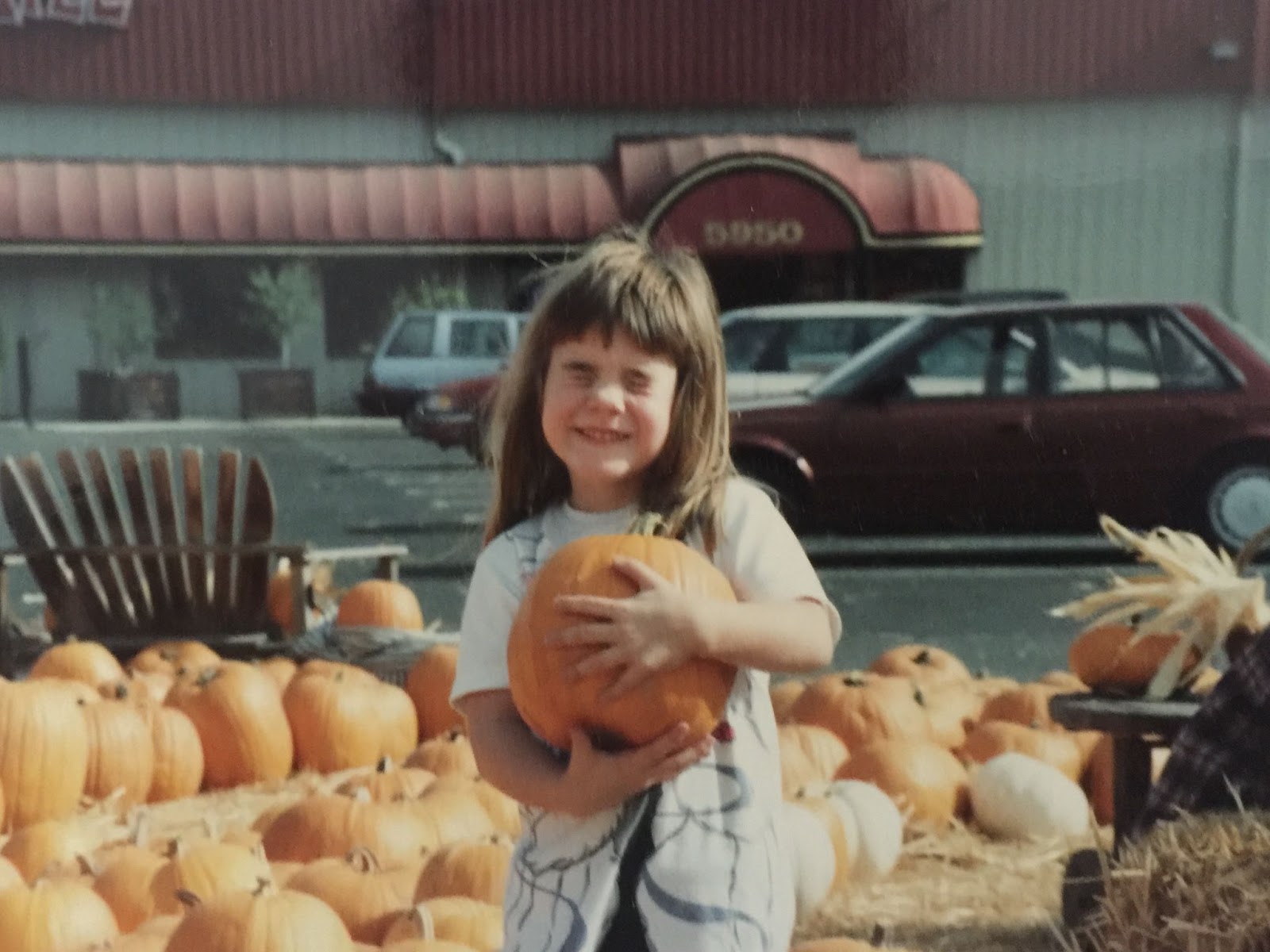 young august holding pumpkin