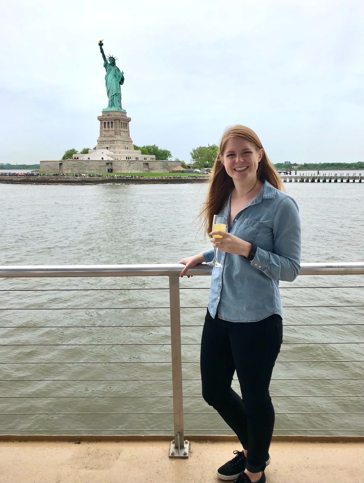 Lyssa Test in front of the Statue of Liberty in New York City