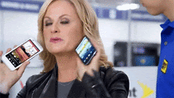 Amy Poehler holding two cell phones