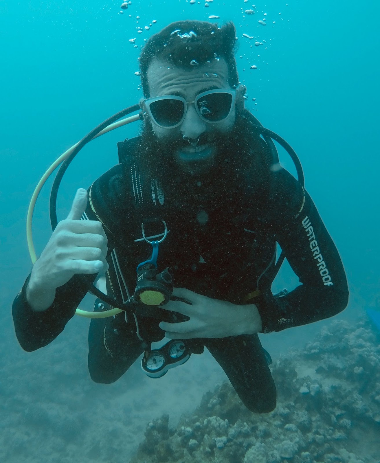 Alex wearing sunglasses he found on the bottom of the ocean while scuba diving