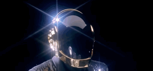 Daft Punk playing bass guitar and drums from the music video for the song Get Lucky