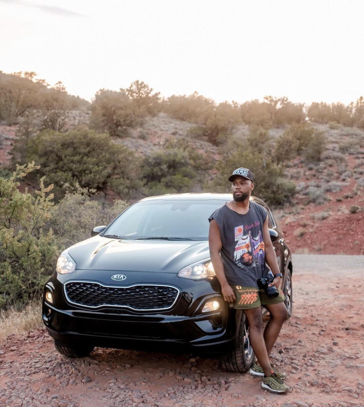 Gyasi, in front of SUV on top of rocky hill in Sedona.