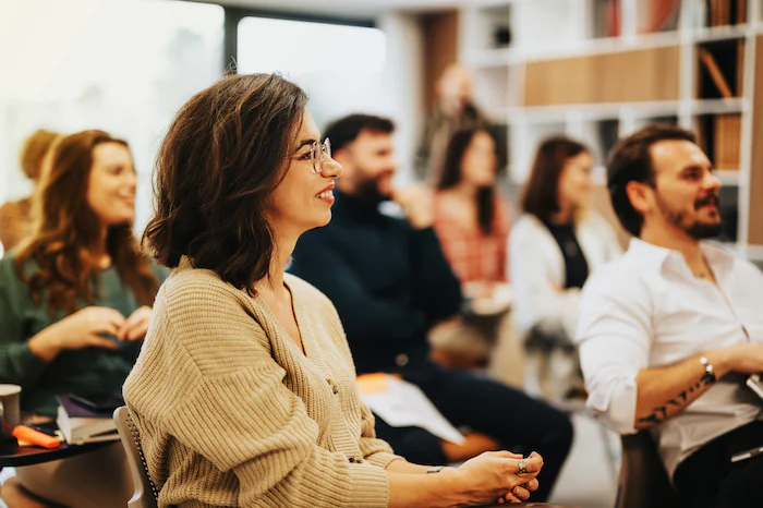 A group of people sitting and attentively listening during a workshop.
