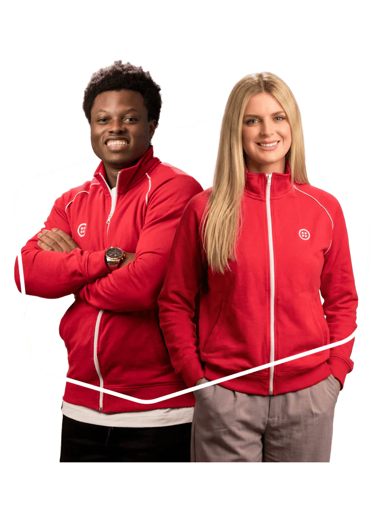 A man and a woman in matching red jackets smiling at the camera.