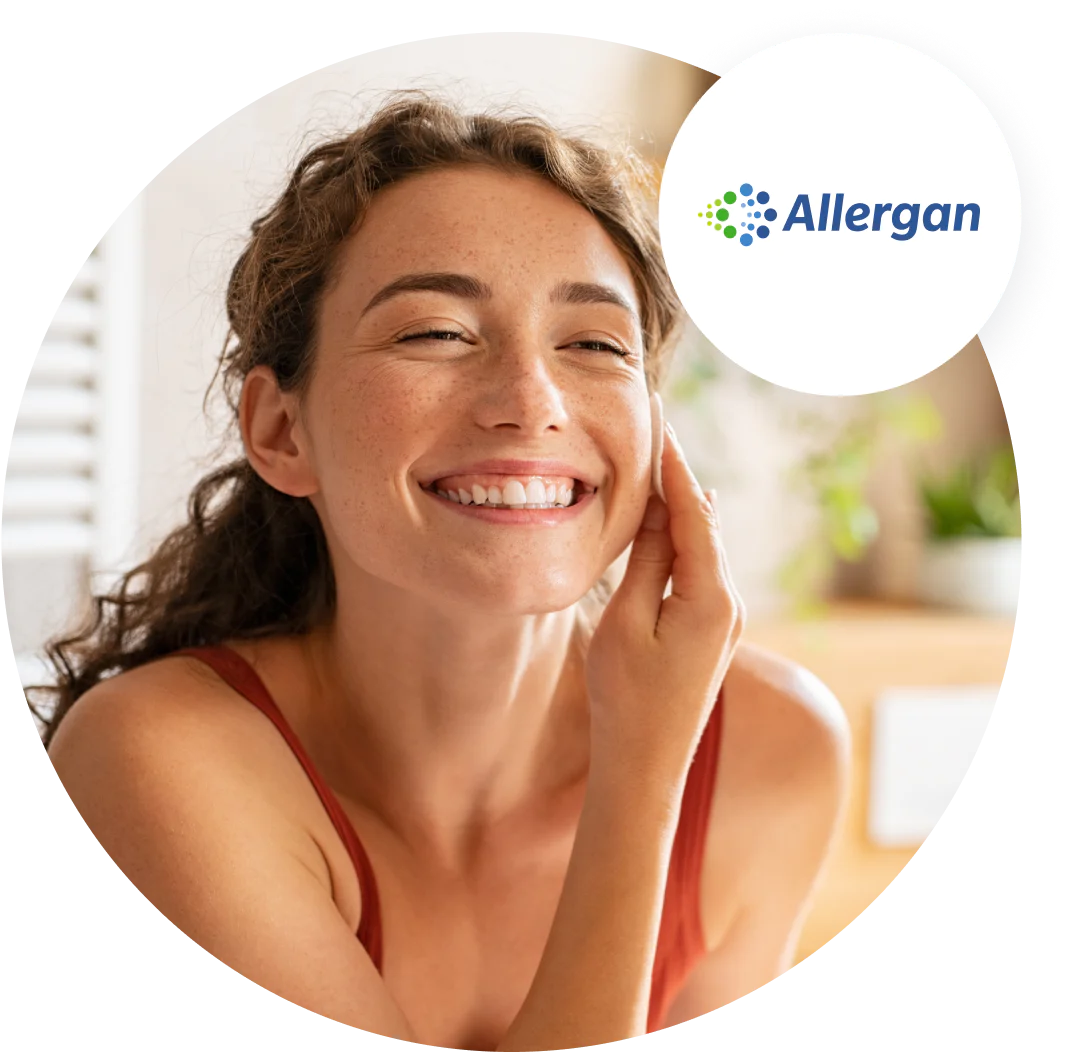 Woman with curly hair smiling and touching her face, Allergan logo in upper right corner