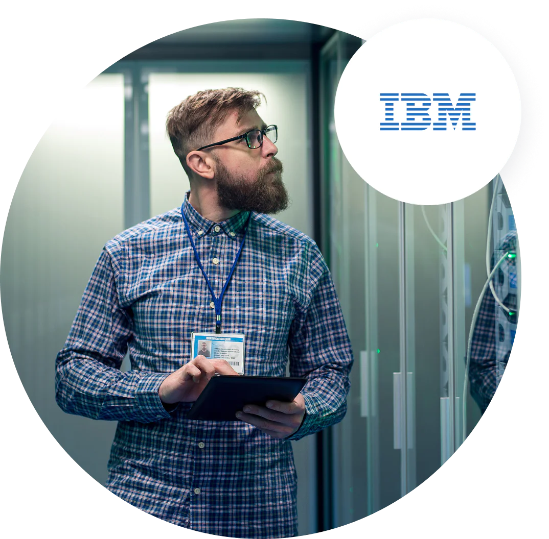Man with beard and glasses using tablet in IBM data center