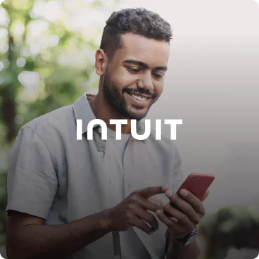 Man using smartphone with Intuit logo overlay Intuit