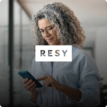 Woman using smartphone with RESY logo Resy