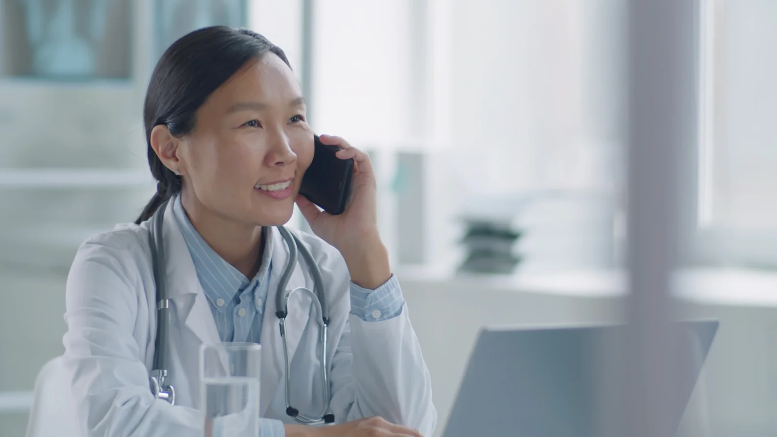 A doctor on the phone with a patient