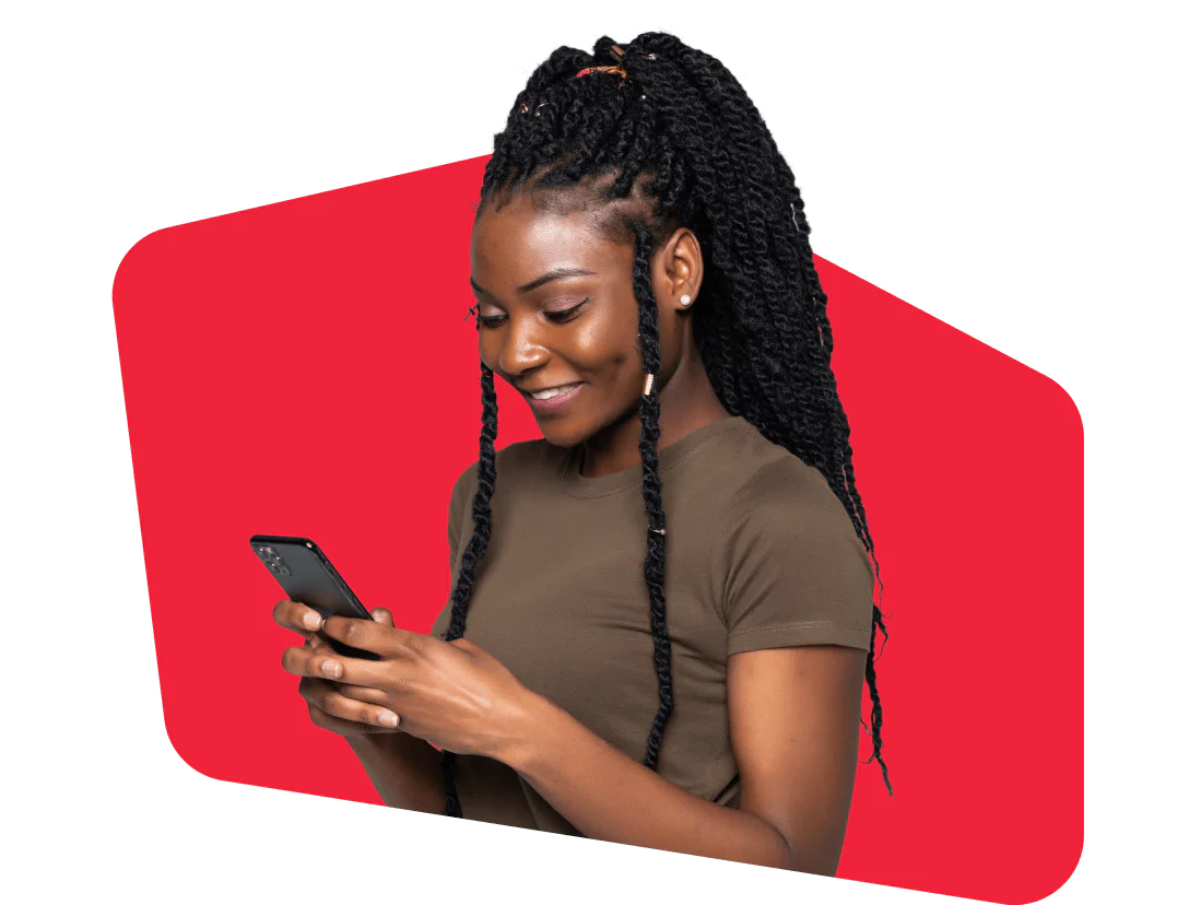 Woman with braided hair smiling and looking at her smartphone