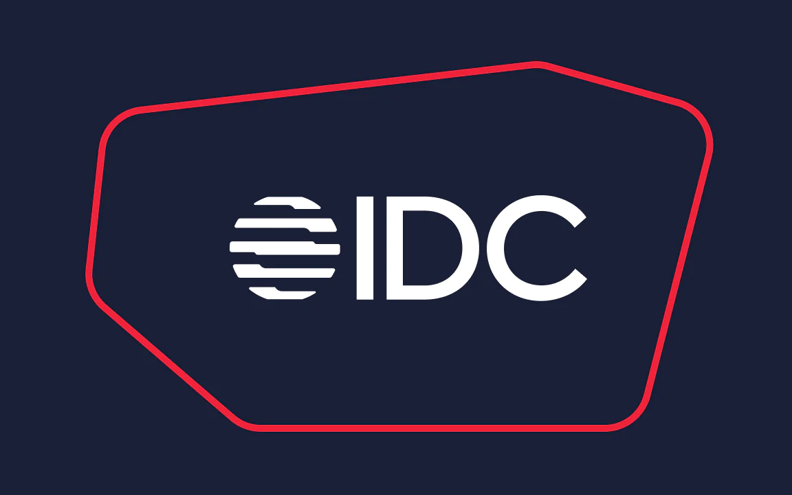 IDC logo with white text inside an irregular red-bordered shape on a dark blue background.