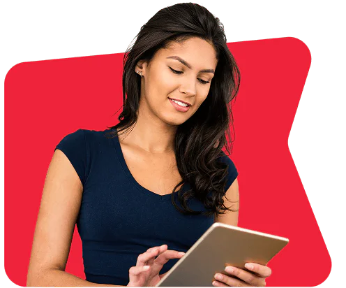 A woman in a navy blue shirt is using a tablet against a red background.