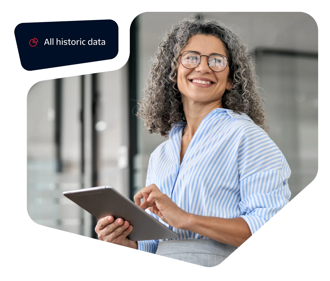 Smiling woman with curly gray hair using a tablet, data overlay reads All historic data.
