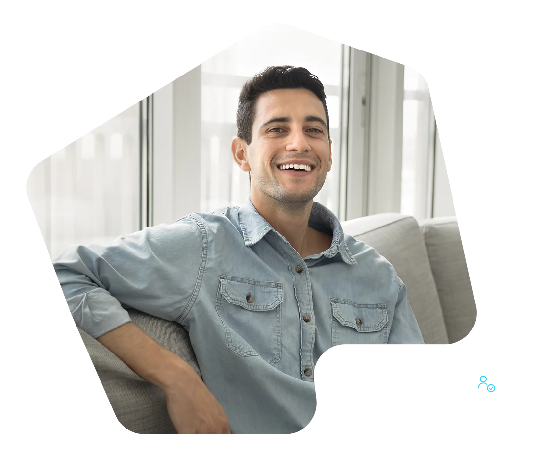 Man smiling while sitting on a couch, with New Signup text displayed in the corner.