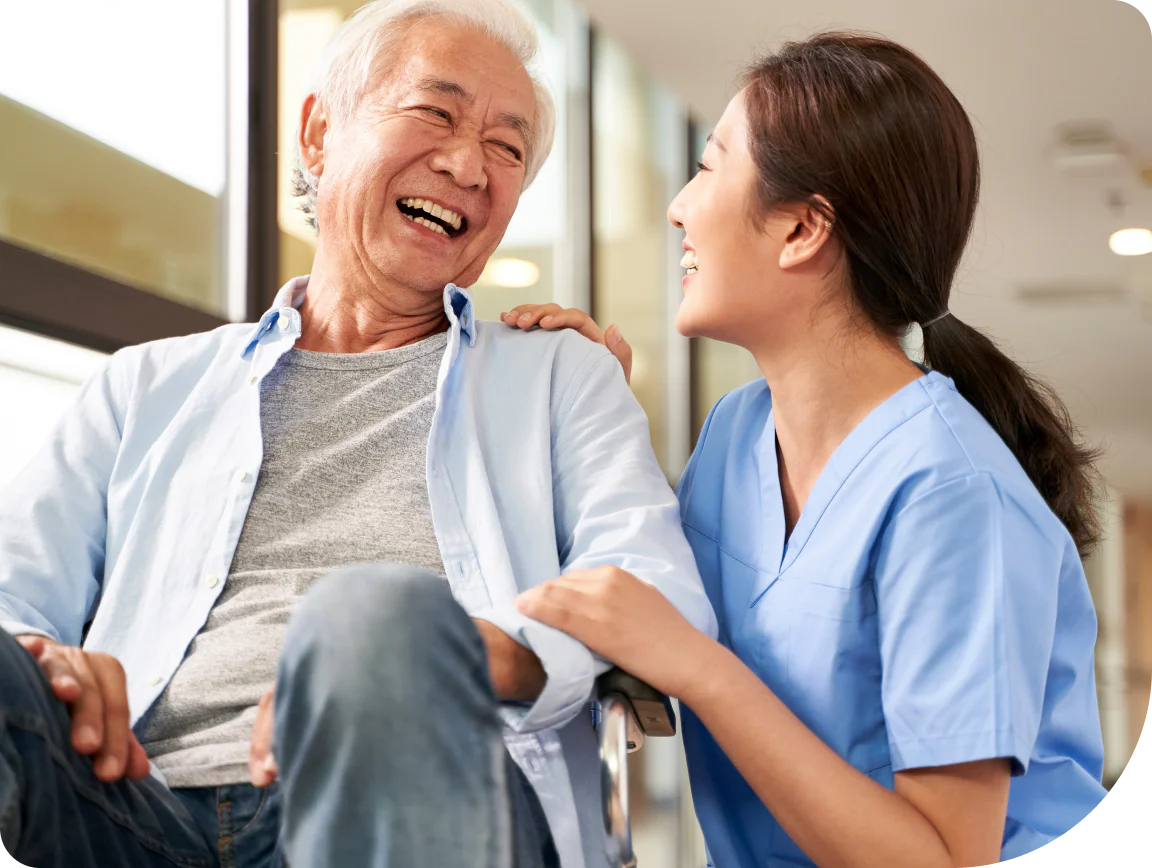 A nurse and patient laughing about a quick recovery.