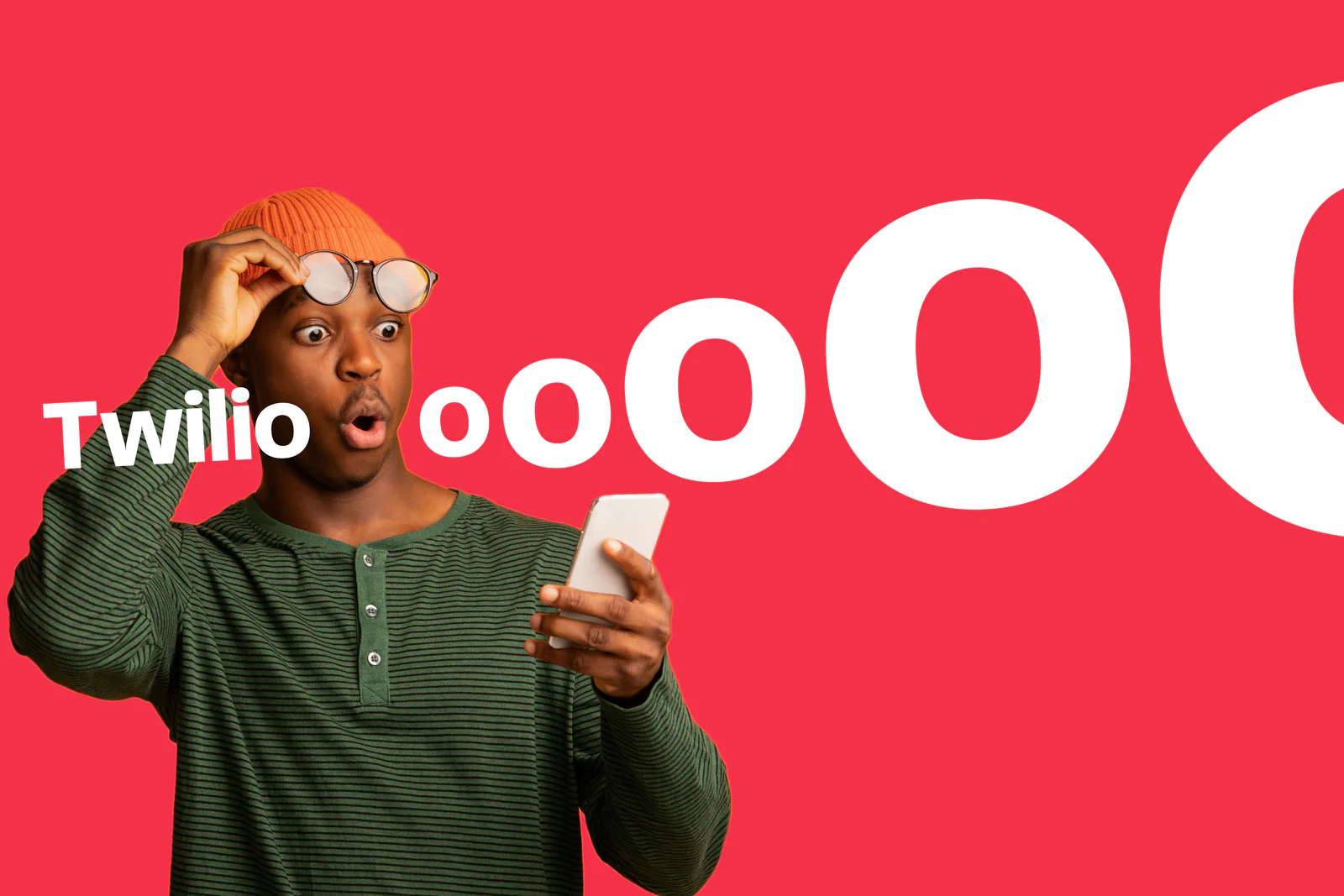 Man in a beanie and glasses looks surprised at his phone in front of a Twilio-themed graphic with bold text.
